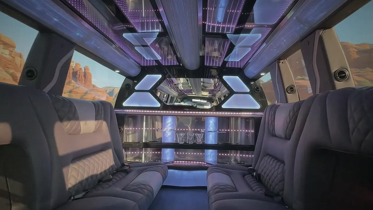 Inside the Cadillac Escalade limo in Greeley: LED light-show ceiling, leather lounge seating and lit bar